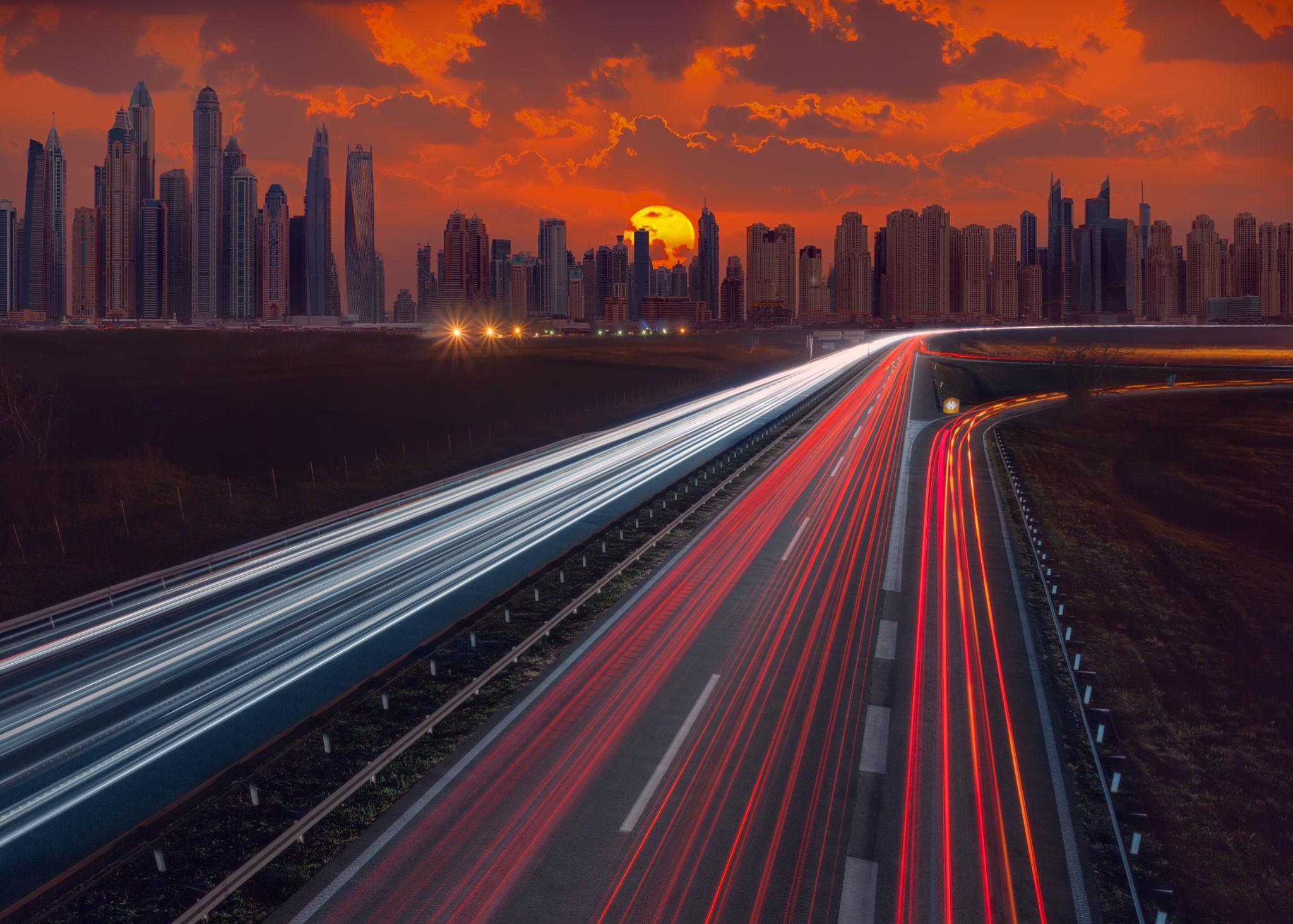 Dubai skyline at sunset with highway light trails, 2026